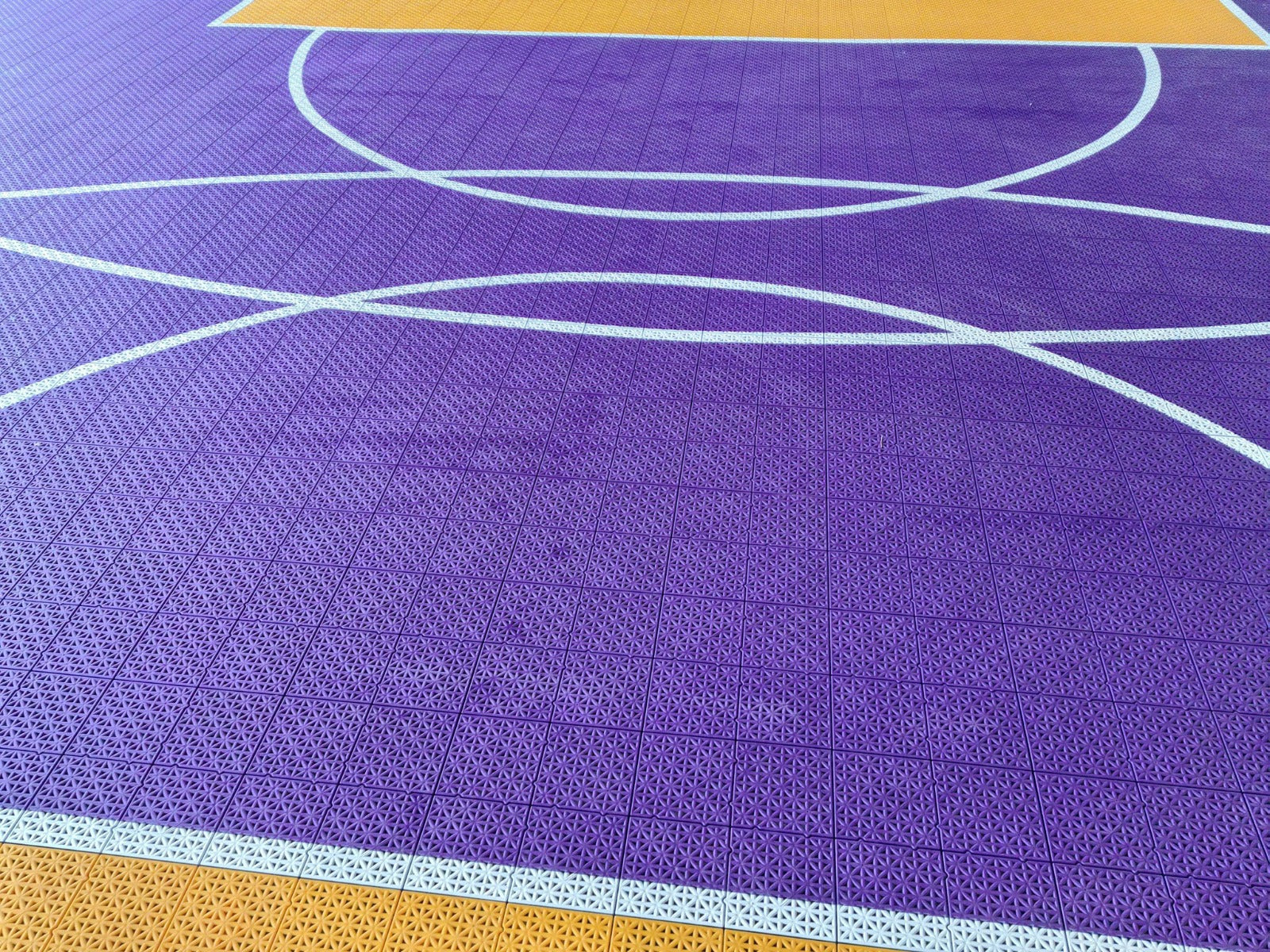 Close view of the white playing lines on the purple B3B court