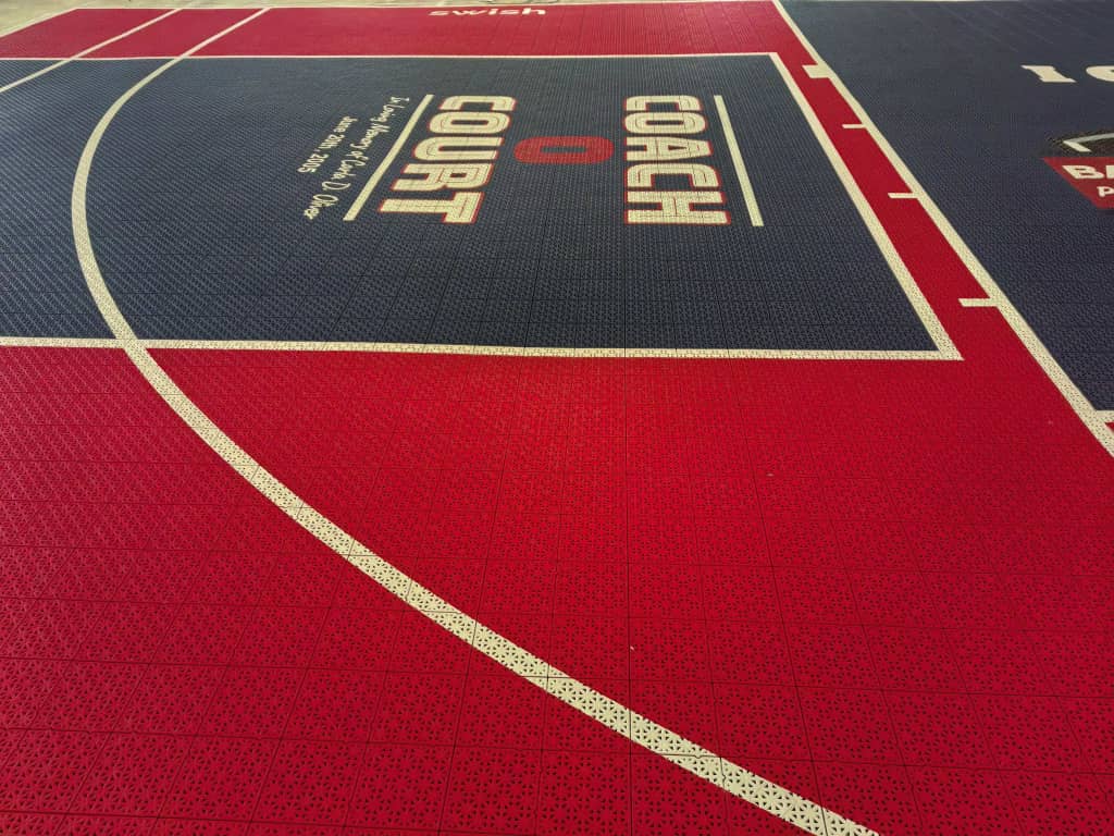 Red surround and navy Coach O Court training area on modular tiles
