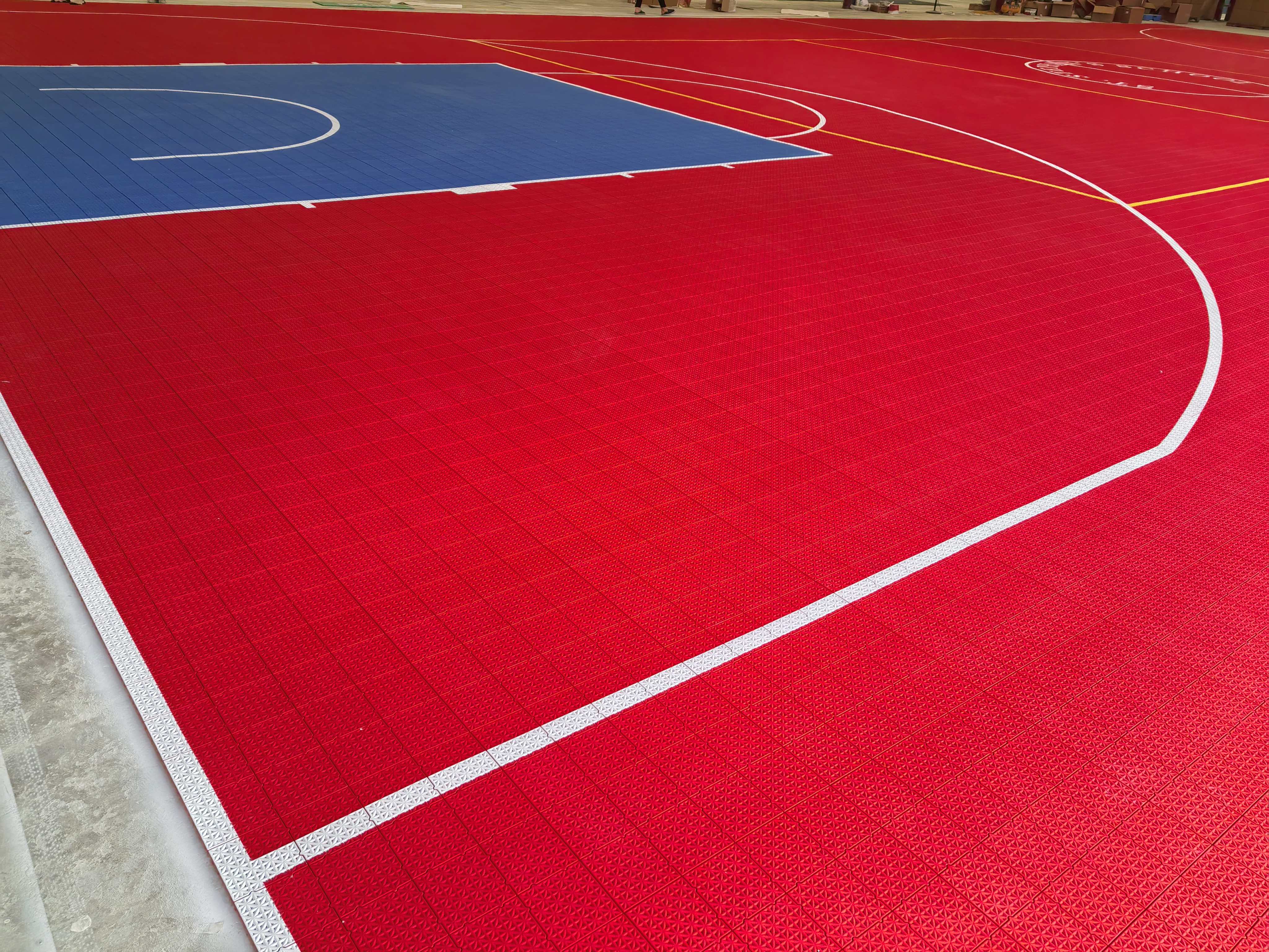 Red court surface, blue key, and white basketball lines on Large Elite tiles