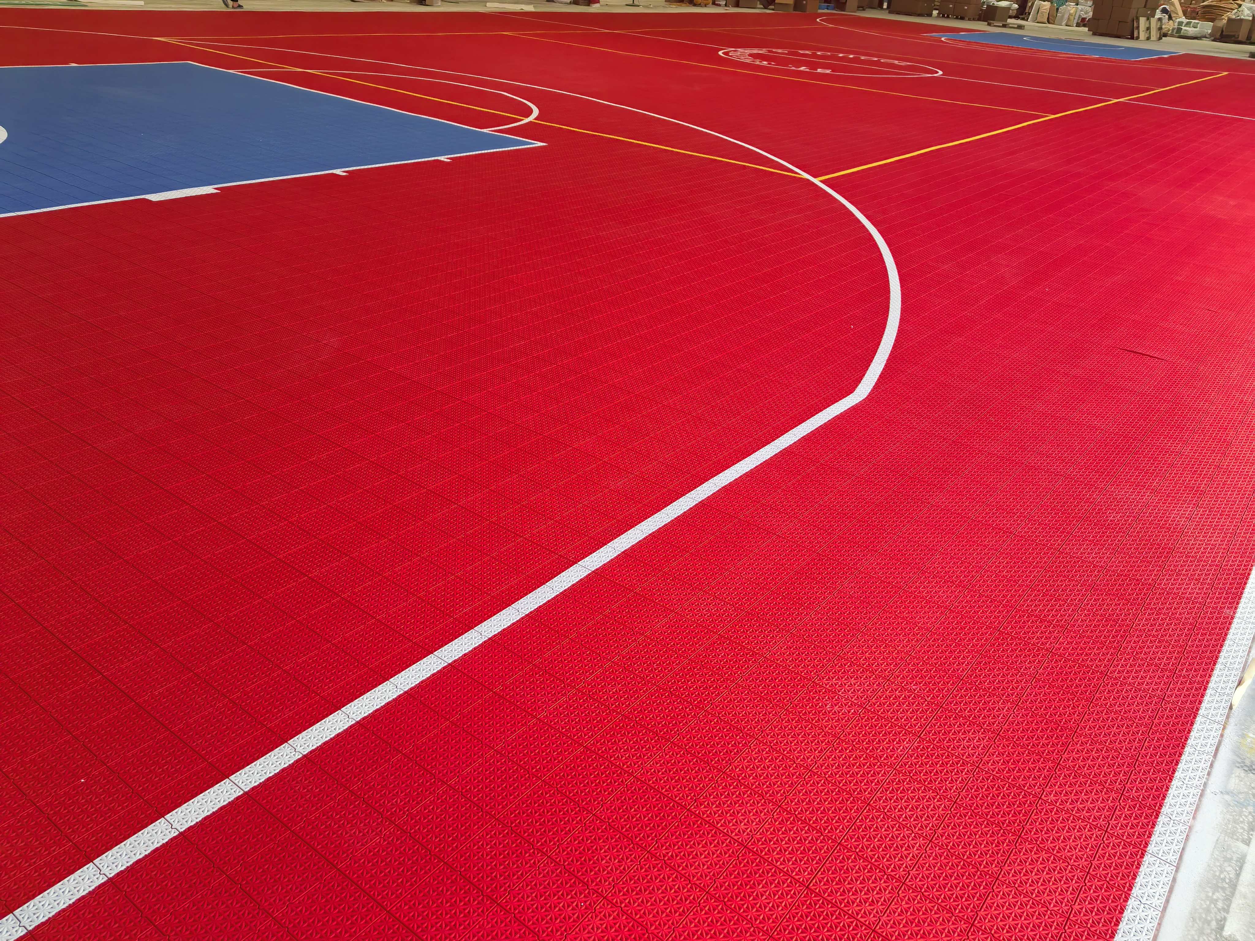 White basketball arc and yellow volleyball lines on the St. Stephen's School court