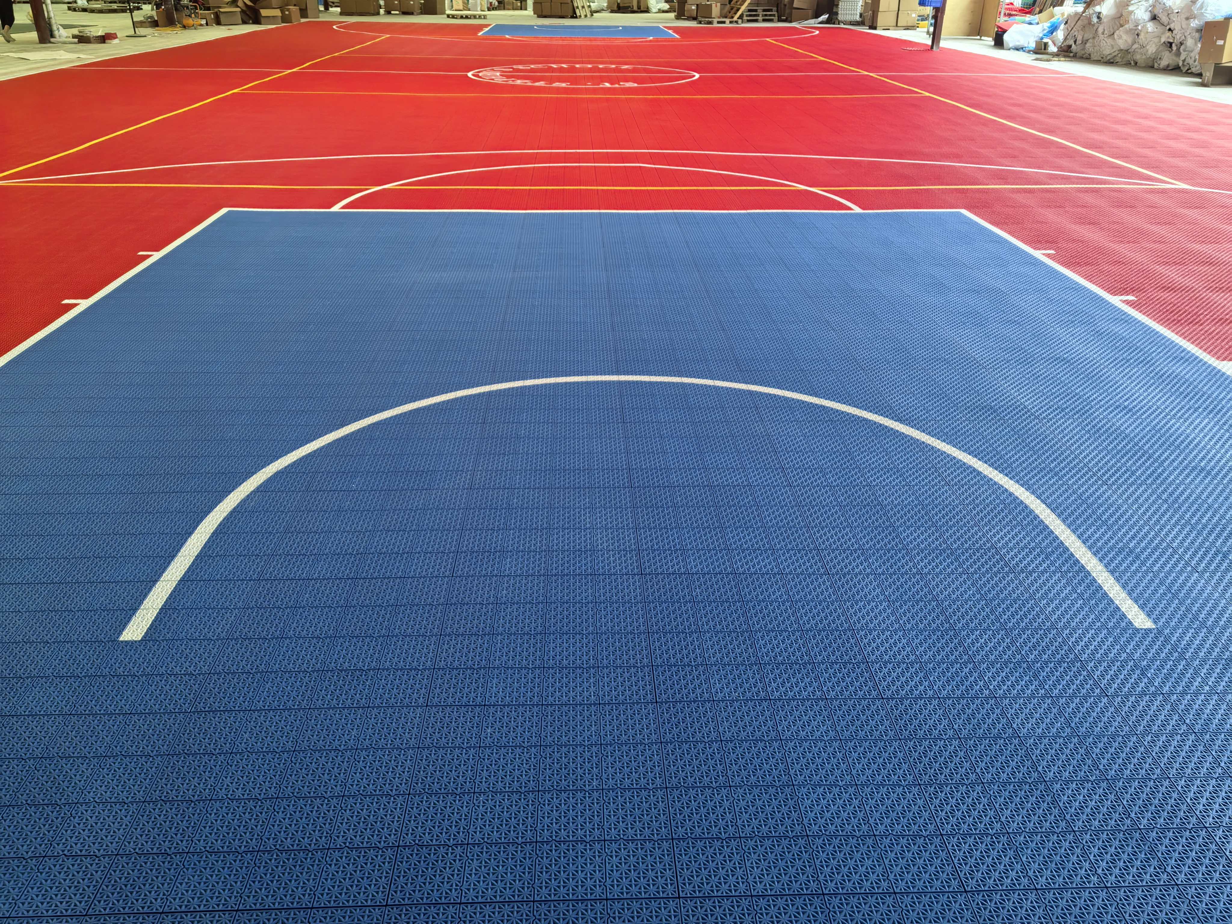 Full-length warehouse view of the red and blue St. Stephen's School court