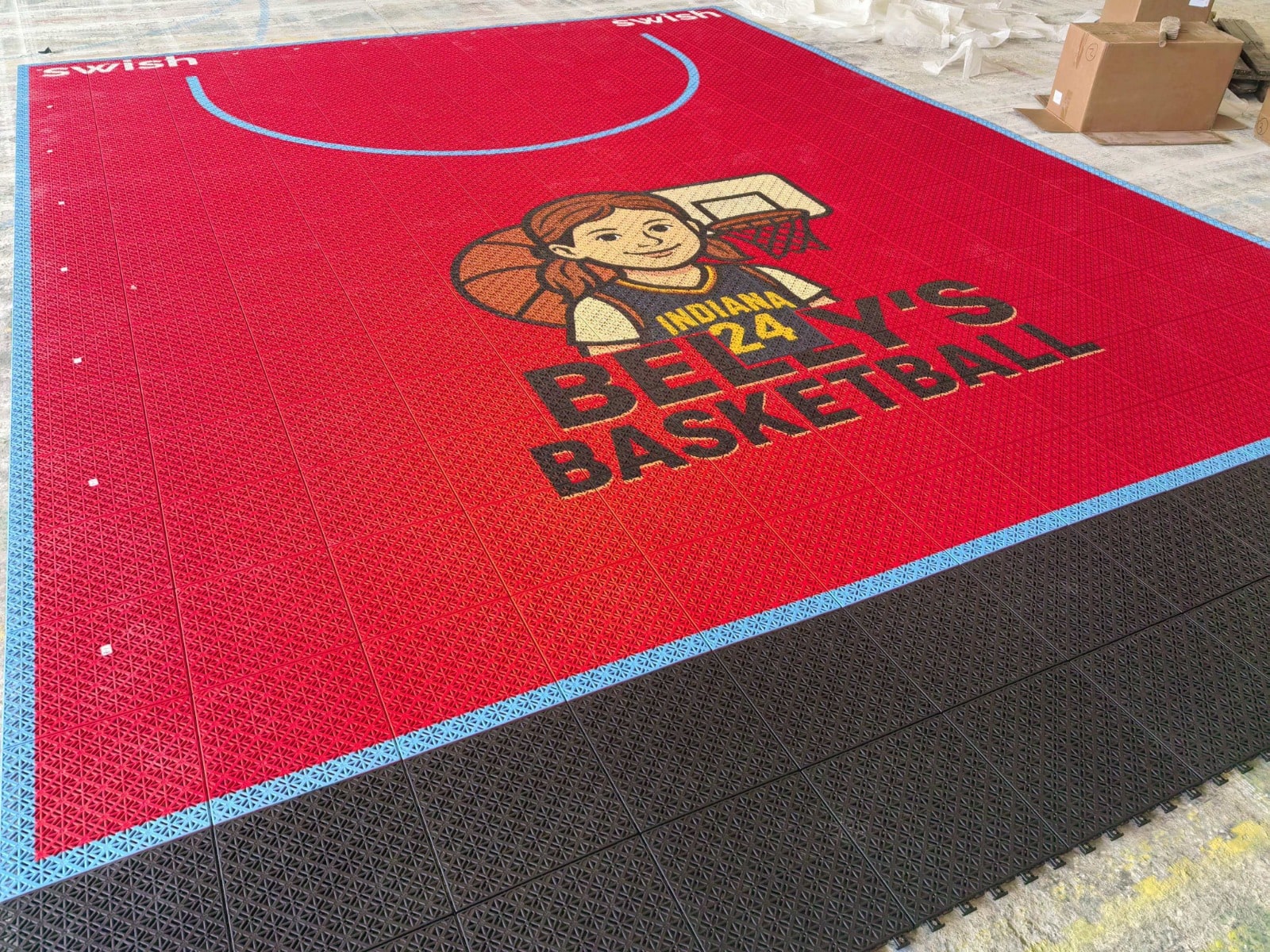 Full Elastic tile court layout with light-blue basketball arc and custom centre artwork, project photo 2