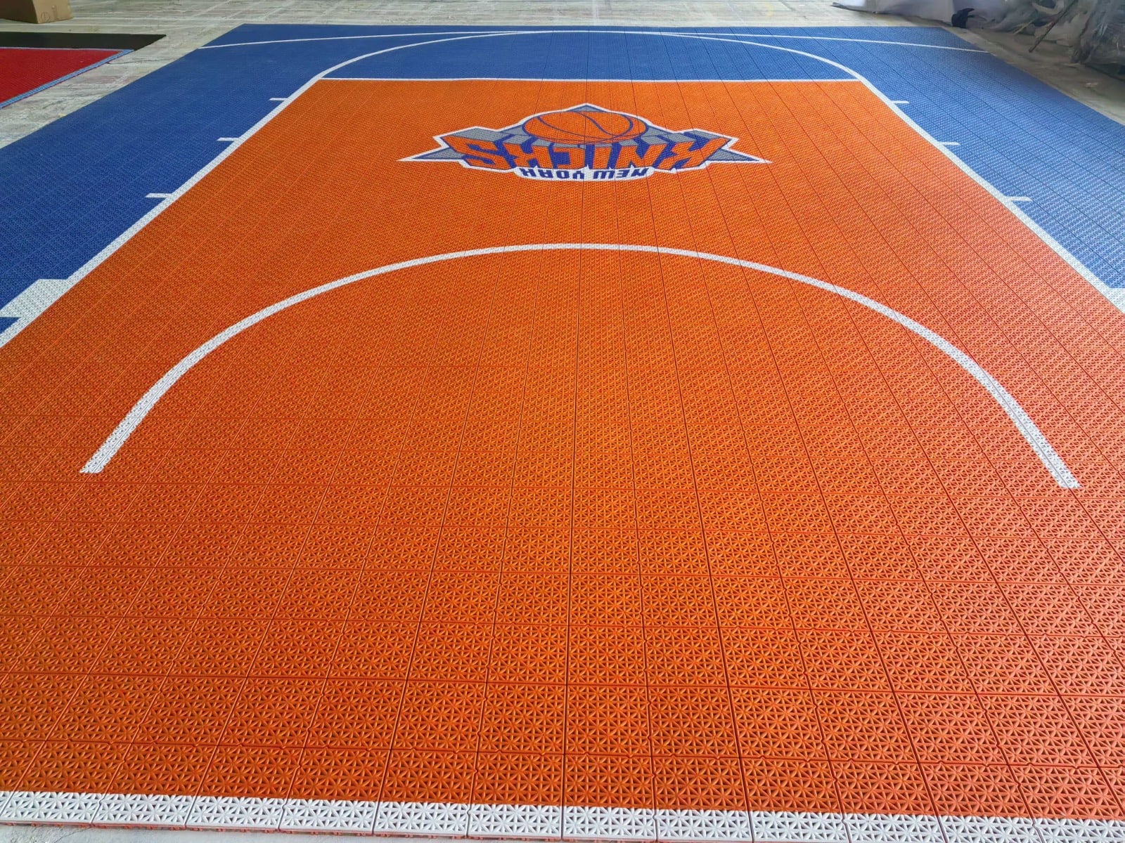 Exact custom white basketball line layout on the completed New York Elite tile court, project photo 4