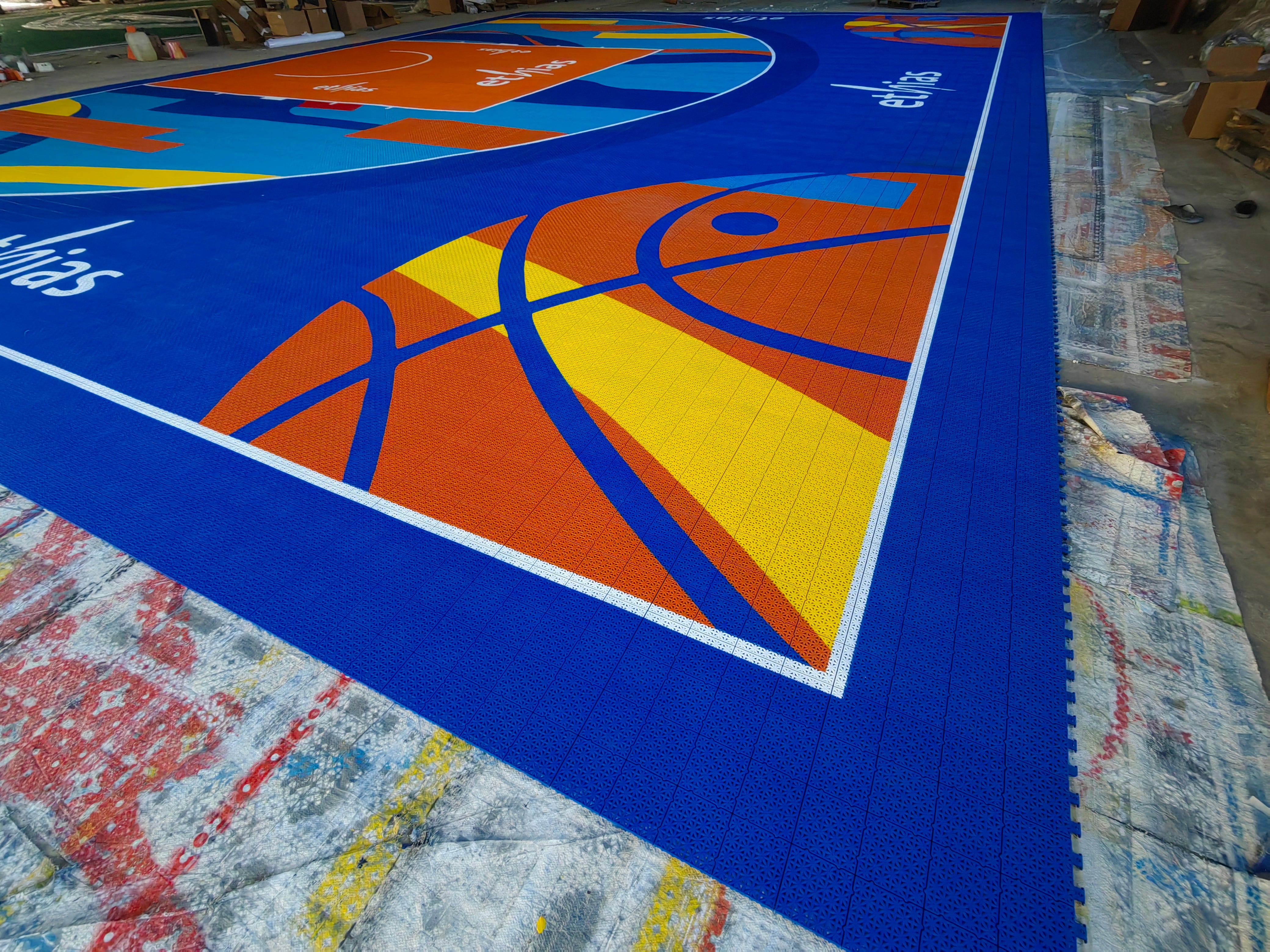 Wide warehouse view of the assembled Ethias 3x3 Masters court