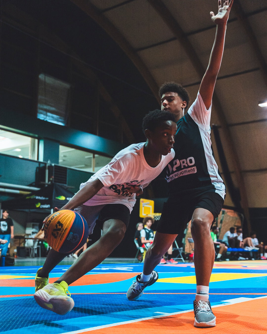 Players competing on a blue and orange court at 3x3 Masters