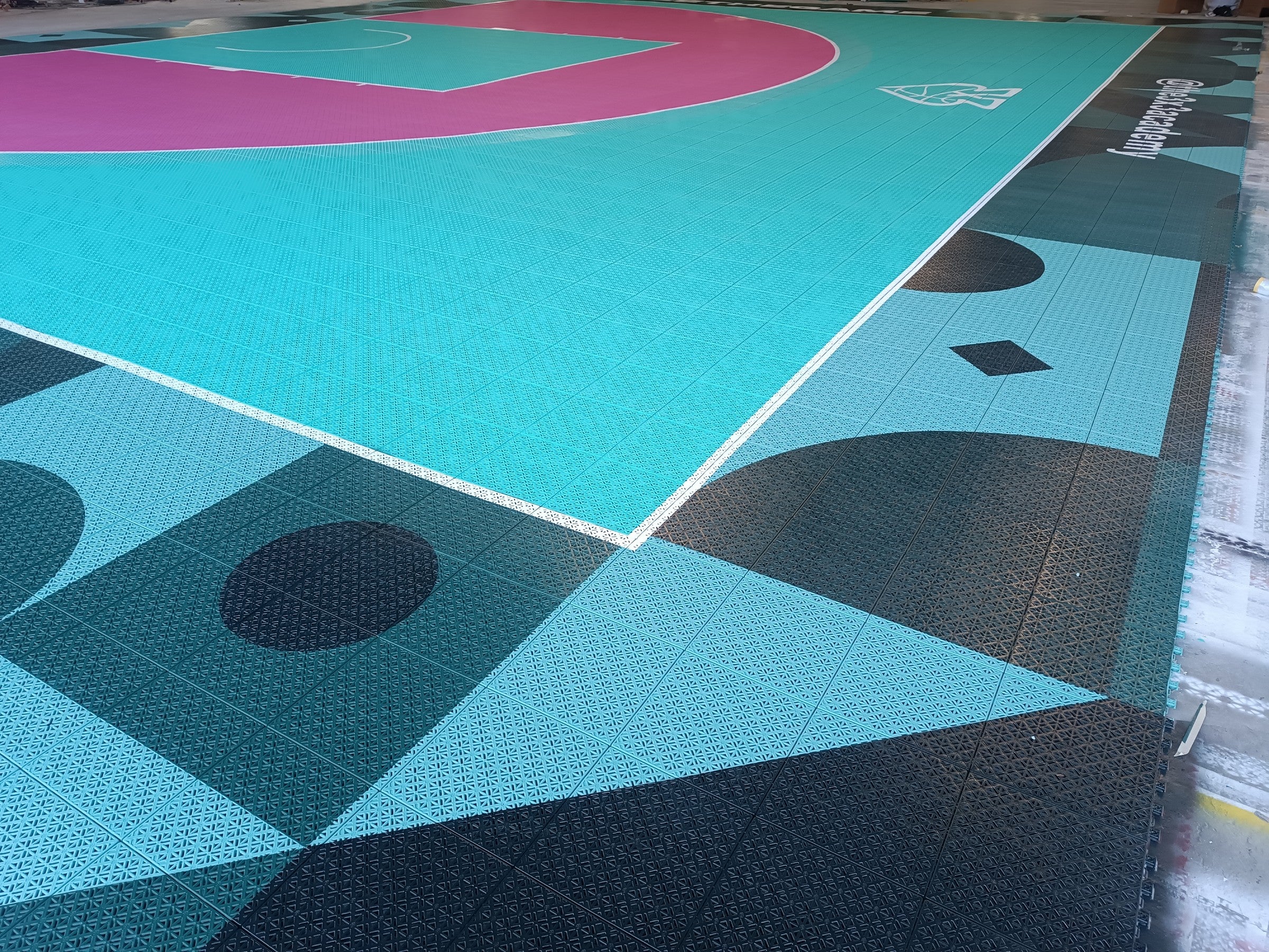 Wide warehouse view of The 3x3 Academy custom basketball court