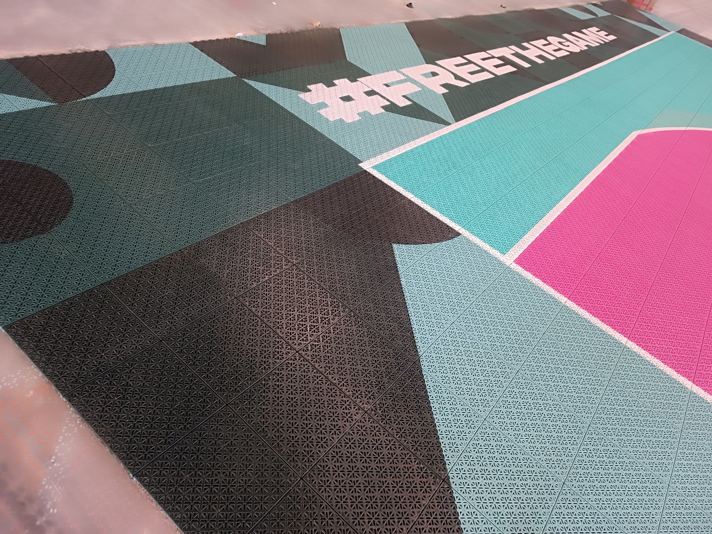 Patterned border and playing-area corner on The 3x3 Academy court