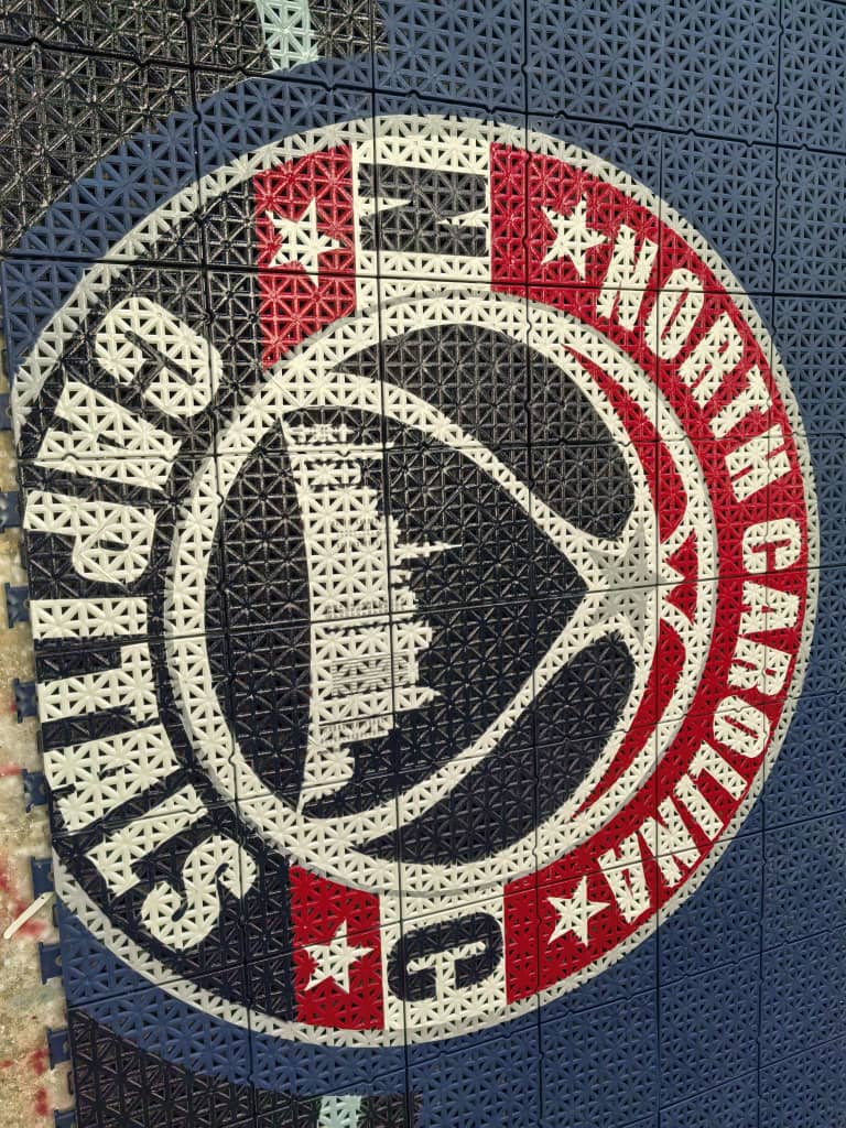 Close view of the North Carolina Capitals circular academy logo