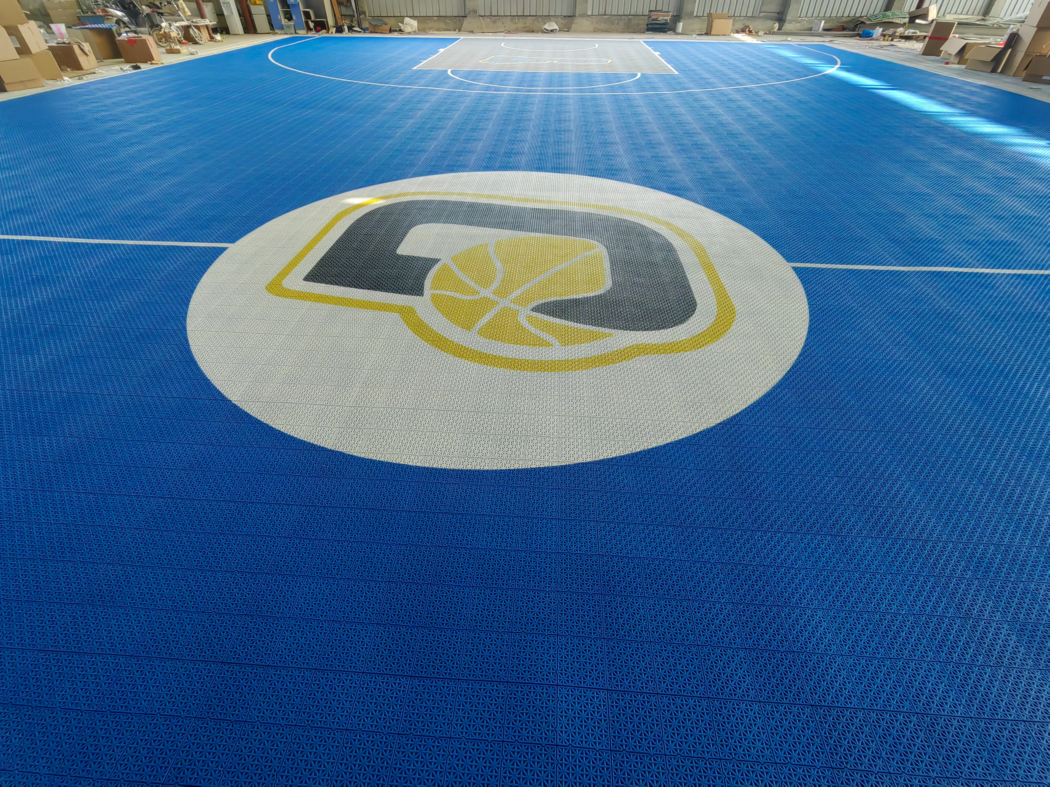 Full-length warehouse view of the Depiro modular basketball court