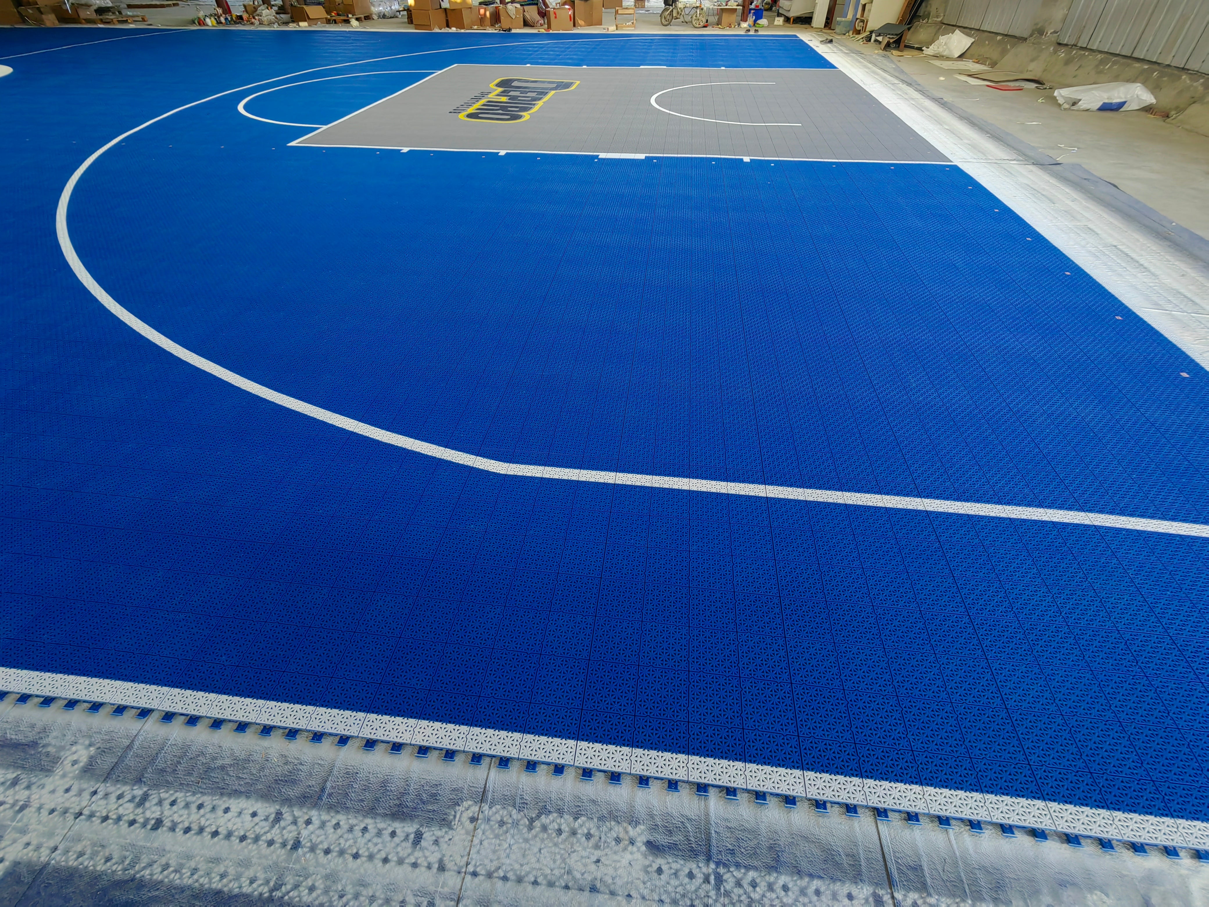 Wide corner view of the finished Depiro court surface in the warehouse