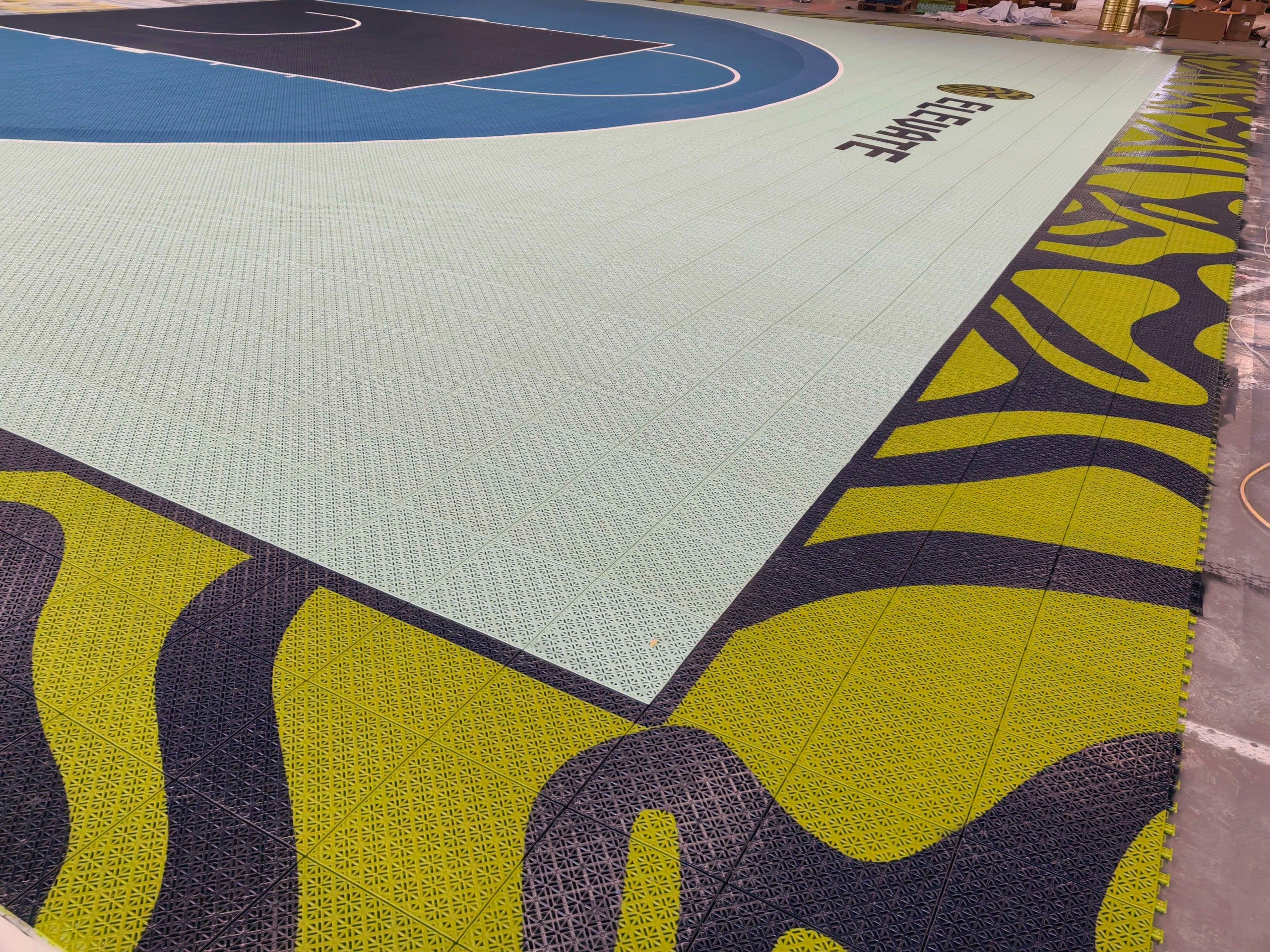 Elevate basketball court with mint playing surface and lime custom border graphics