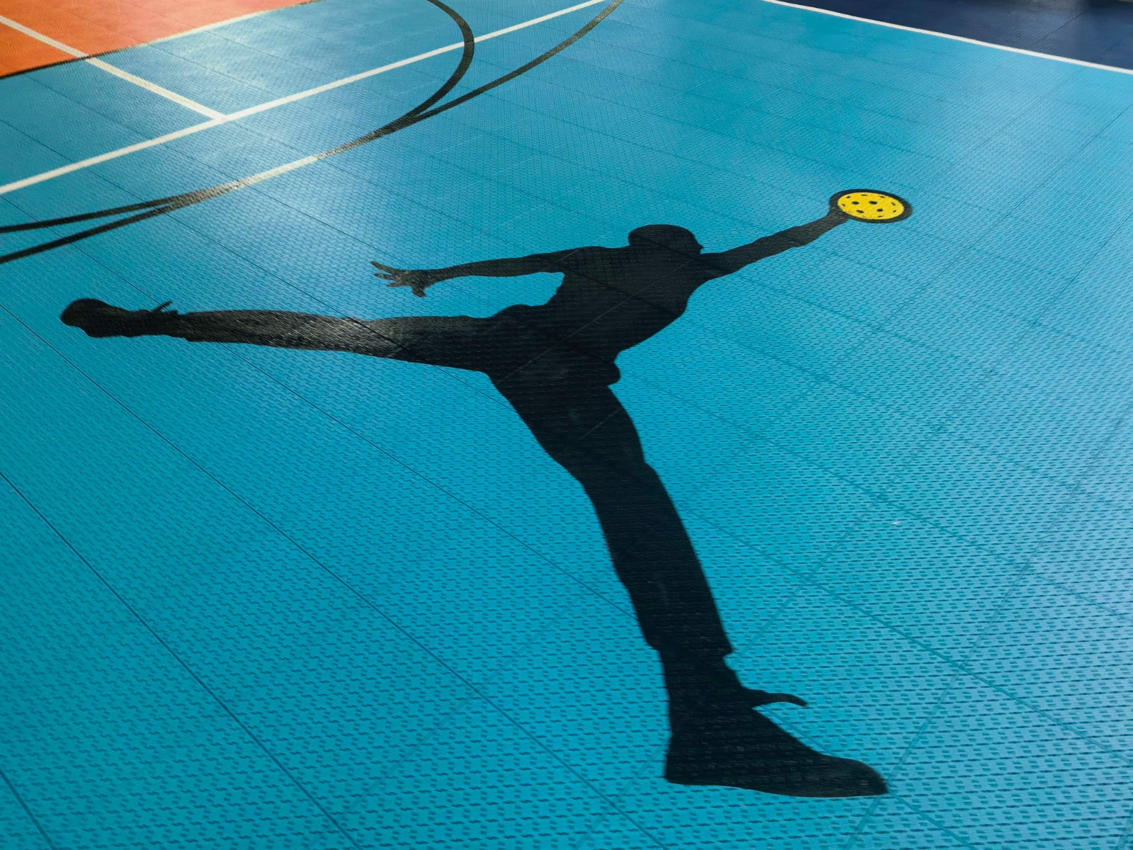 Athletic silhouette graphic printed on the turquoise Jumpman court tiles