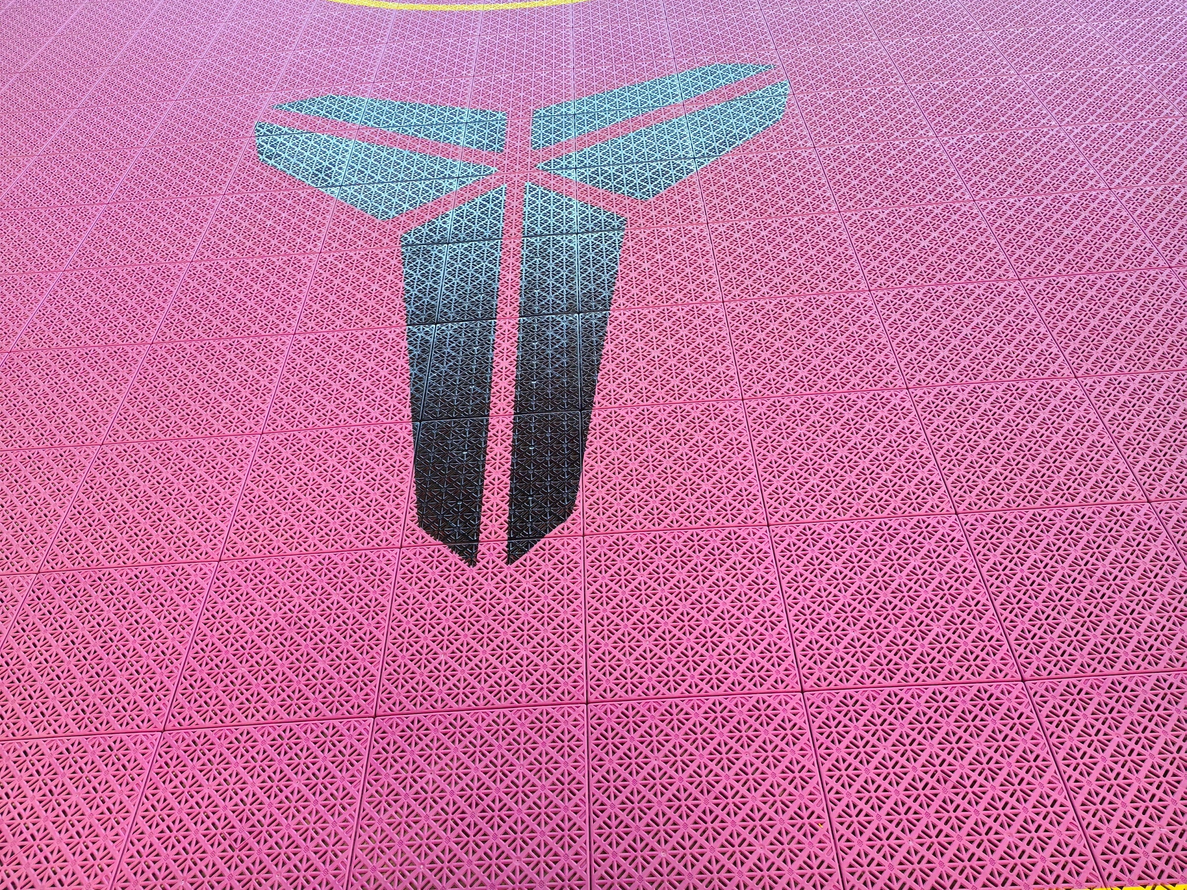 black pink and yellow Kobe-inspired one-hoop Elastic tile backyard basketball court in Belgium, project photo 1