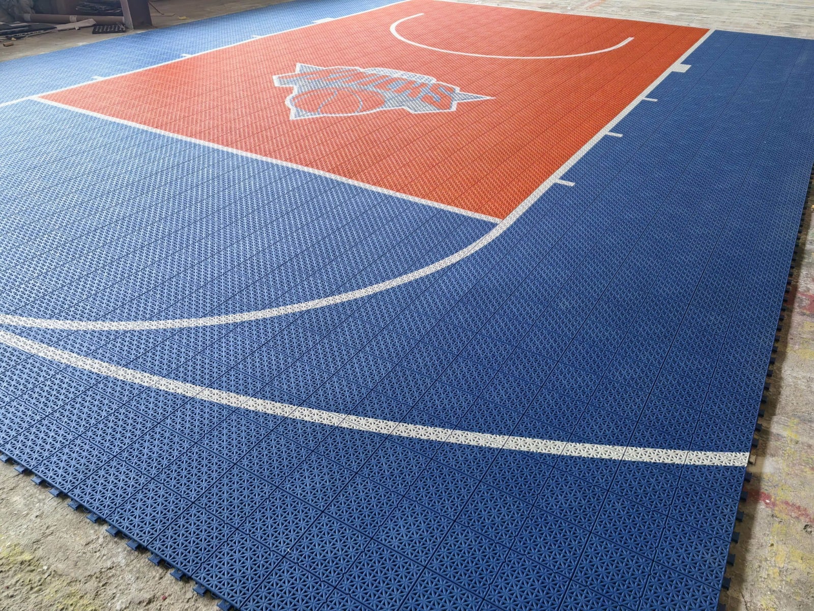 Blue and orange New York Knicks-inspired Elite tile basketball court, project photo 1