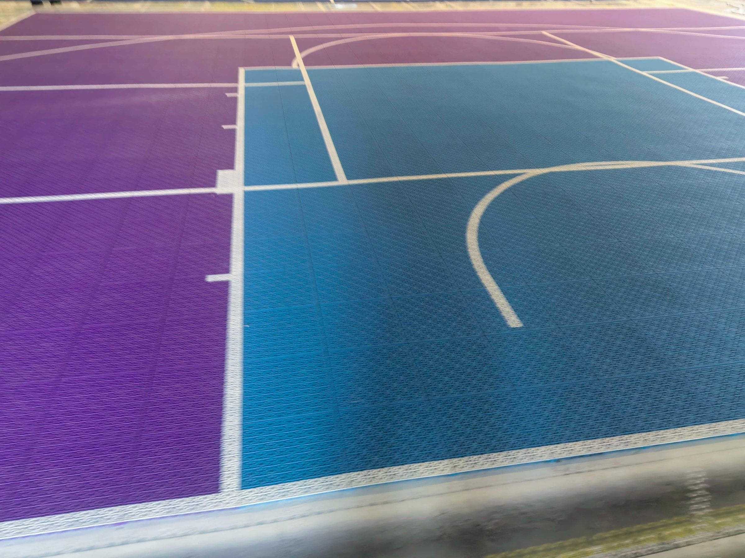 Teal key, restricted-area arc, free-throw arc, and purple perimeter on the Québec court, project photo 2