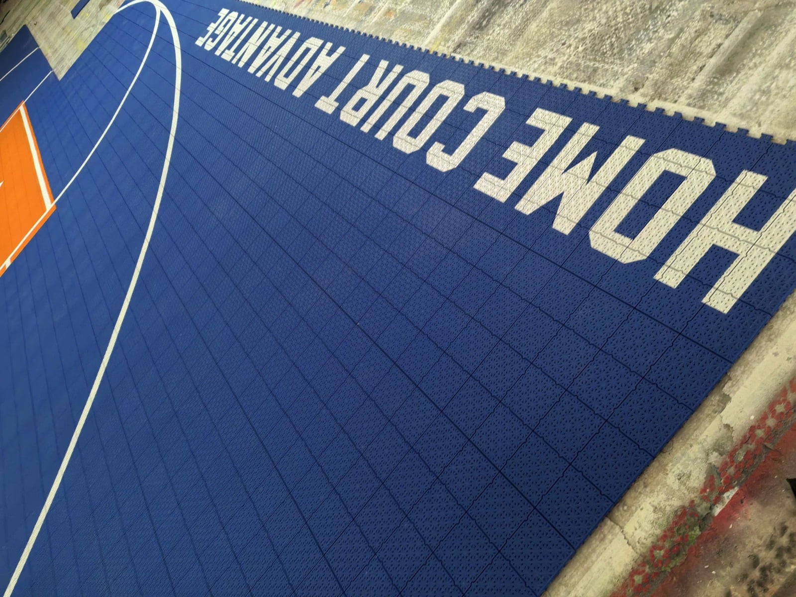 Home Court Advantage artwork and dual white arcs on the blue Elite tile surface, project photo 3